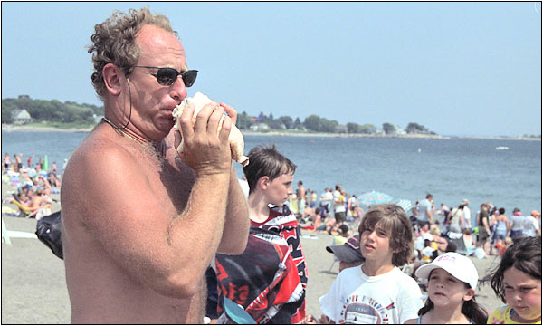 Randy blowing the conch to announce the awards ceremony.